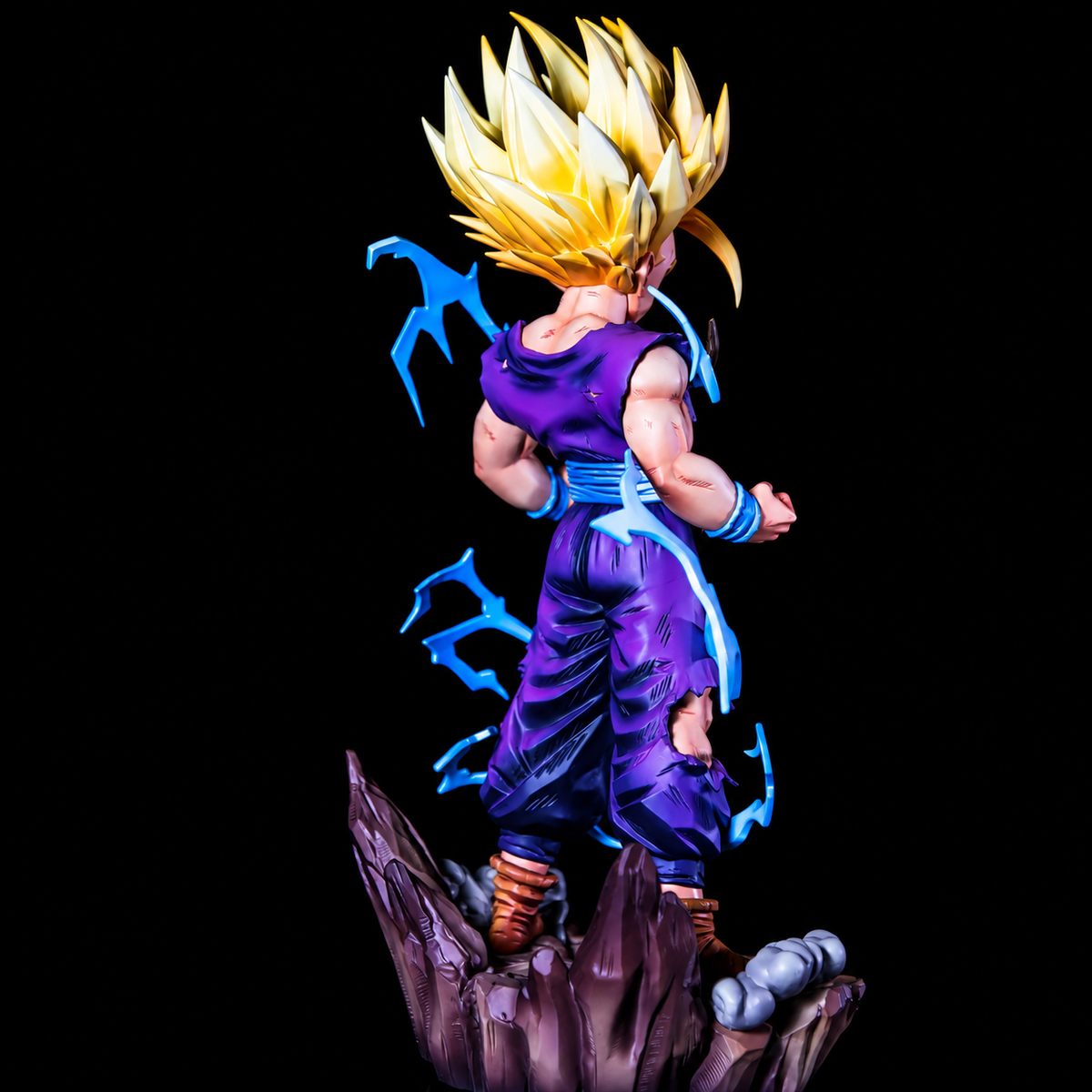 Vue arrière de Gohan Super Saiyan 2 avec tenue déchirée et effets d’énergie